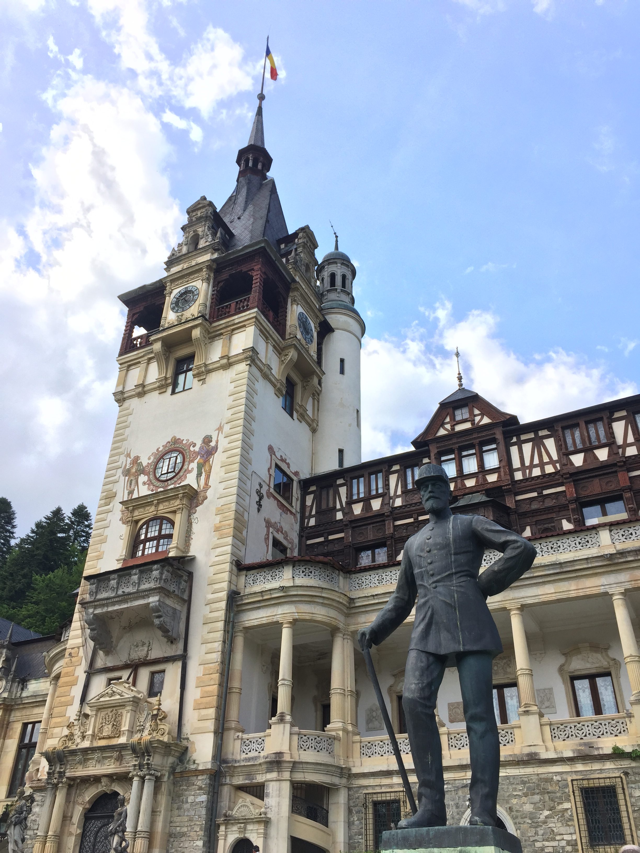 A statue in front of Peleș Castle