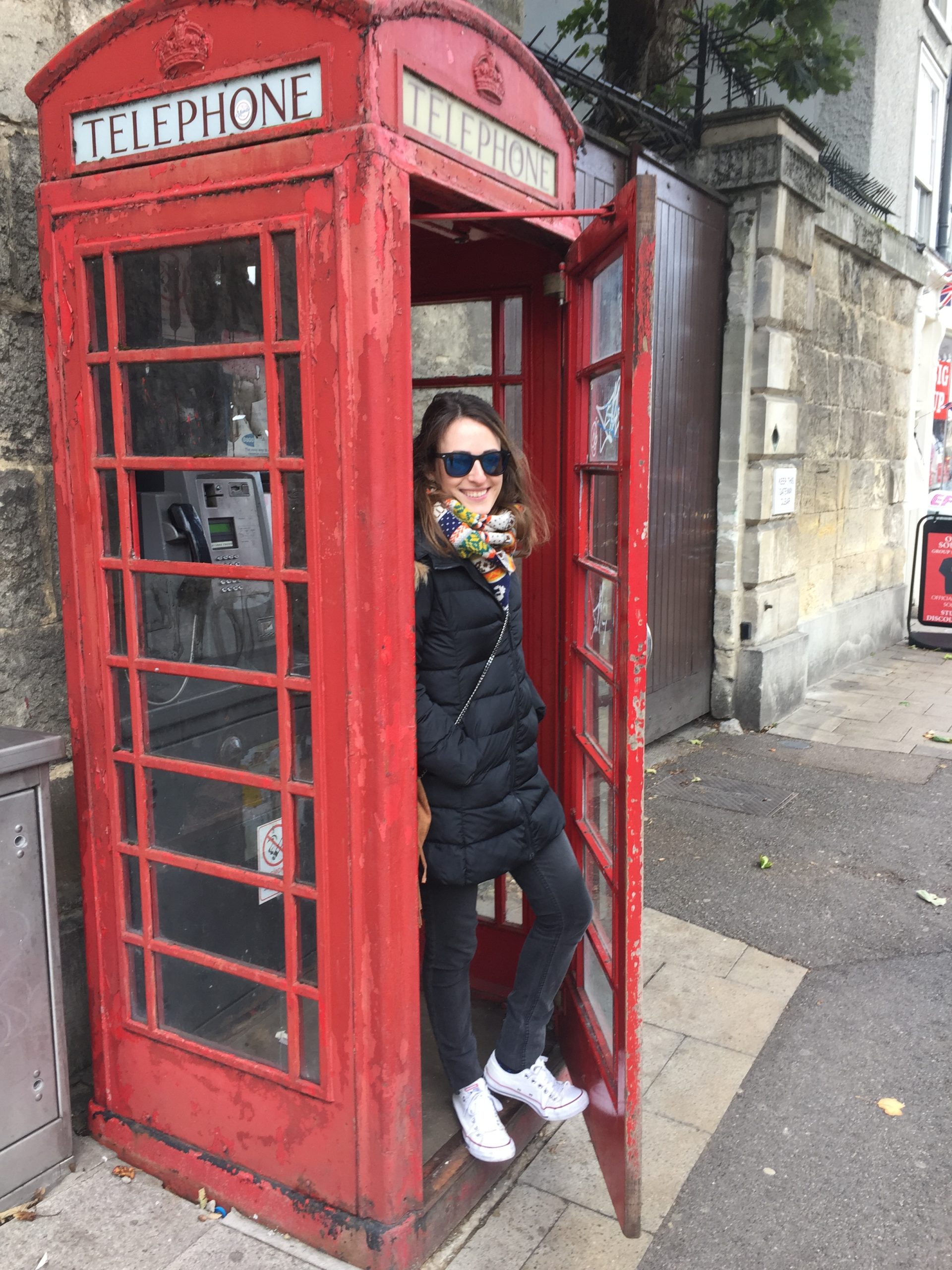 Posing at a telephone box