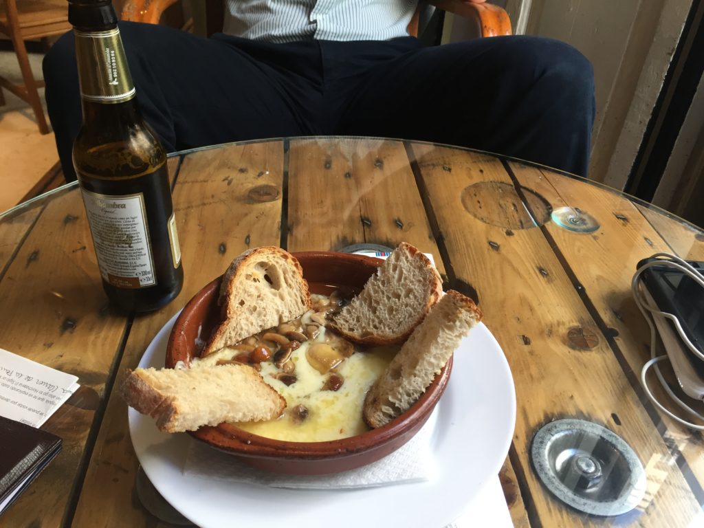 Enjoying some provolone cheese with mushrooms and truffle oil at Ubik Café
