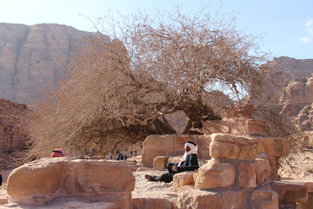 Two Bedouins sitting in the shadow