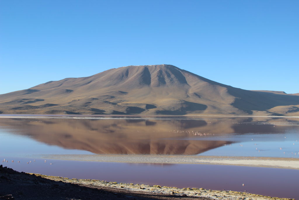 An imposing mountain reflected on the Laguna Colorada