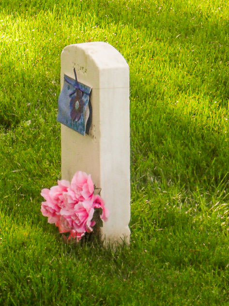 Flowers and a letter on a gravestone