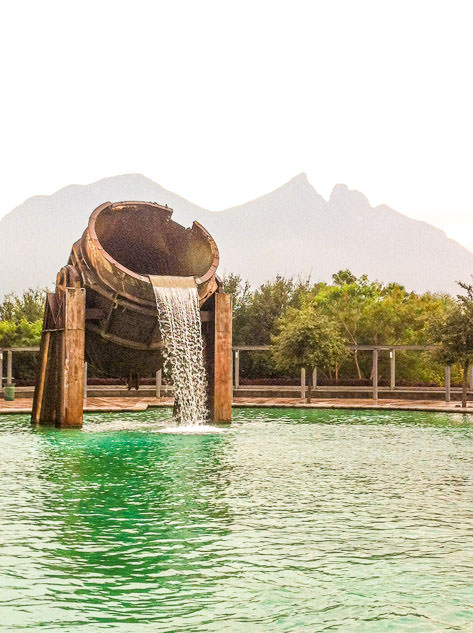 An original fountain in Parque Fundidora with Cerro de la Silla in the background