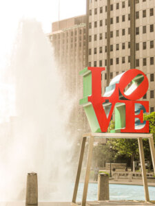 LOVE sculpture and geyser fountain at Love Park, a lively photo spot in downtown Philadelphia