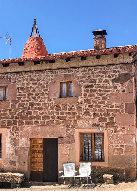 The typical 'chimeneas serranas' in a house in Castrovido