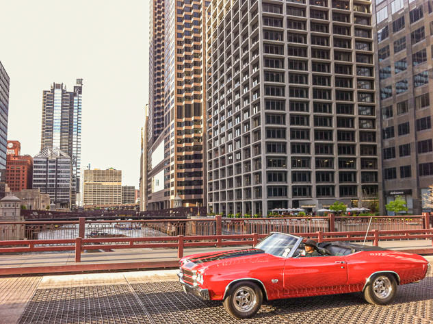 A car drives on a bridge over the Chicago River