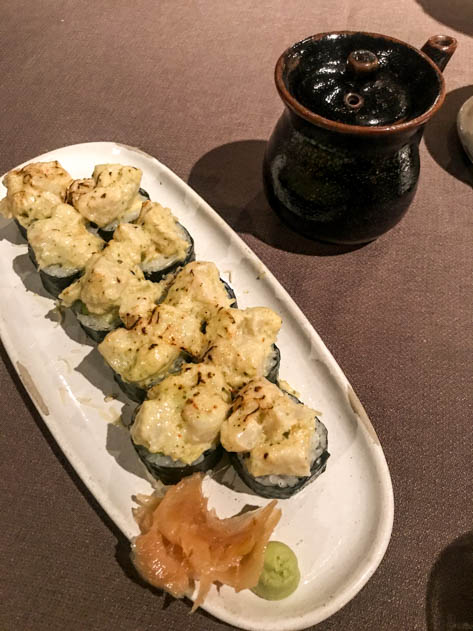 Sushi with scallops and grilled cheese on top