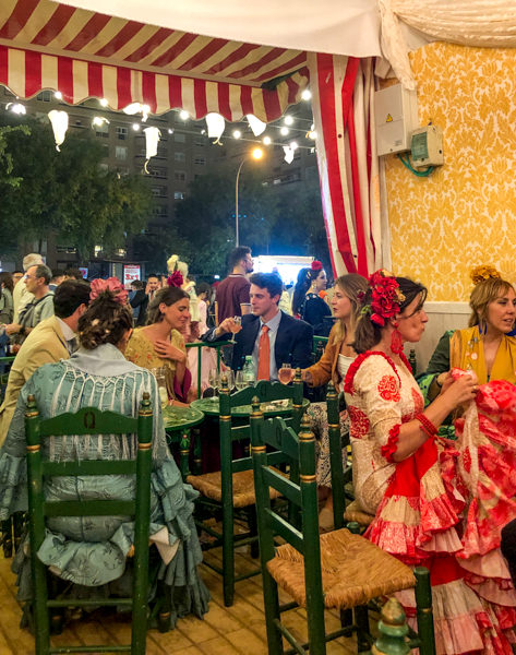 People eating and drinking in a caseta