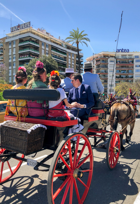 Family on a horse-drawn carriage in Sevilla