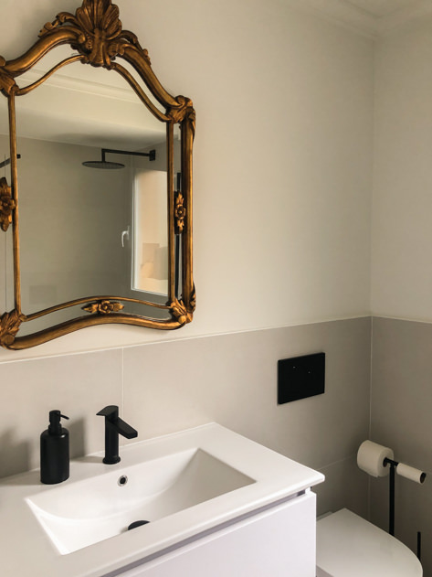 New sink and toilet with a mirror from the property