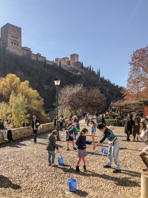Kids playing with the Alhambra in the background