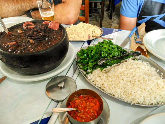 Eating feijoada, the most traditional Brazilian dish