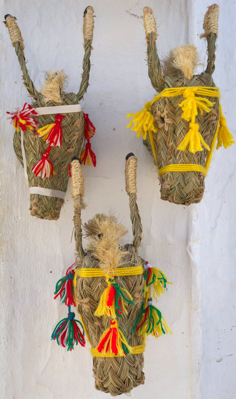 Colorful donkey heads made of esparto in Mijas