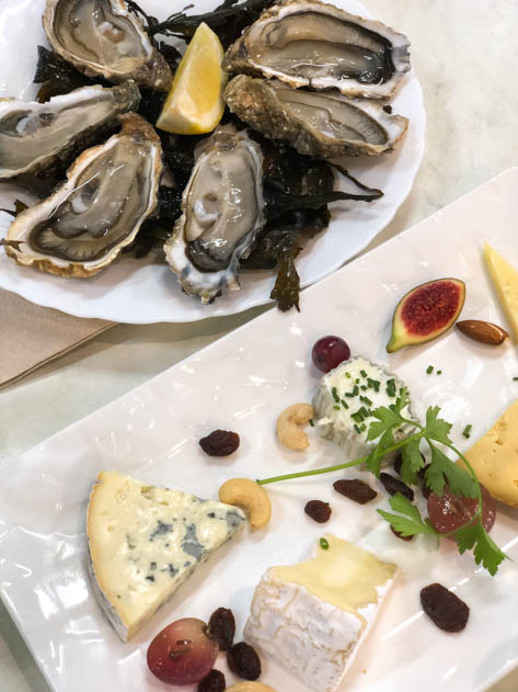 Fresh oysters and cheese at Chez Jean-Mi in Marché des Capucins