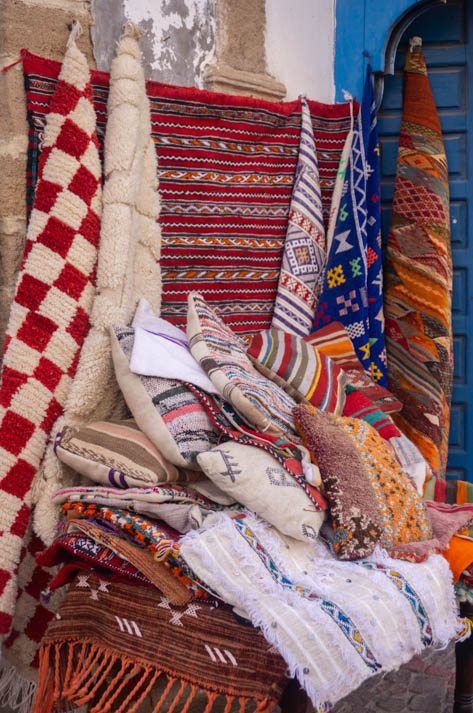 Colorfuls rugs and cushions in a shop in Essaouira