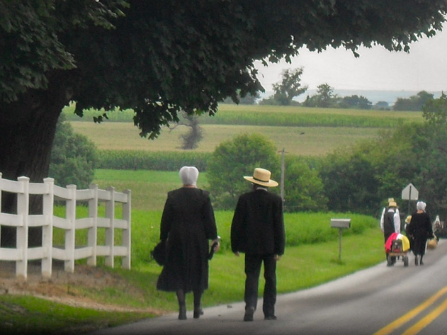 Amish couple walking along rural road