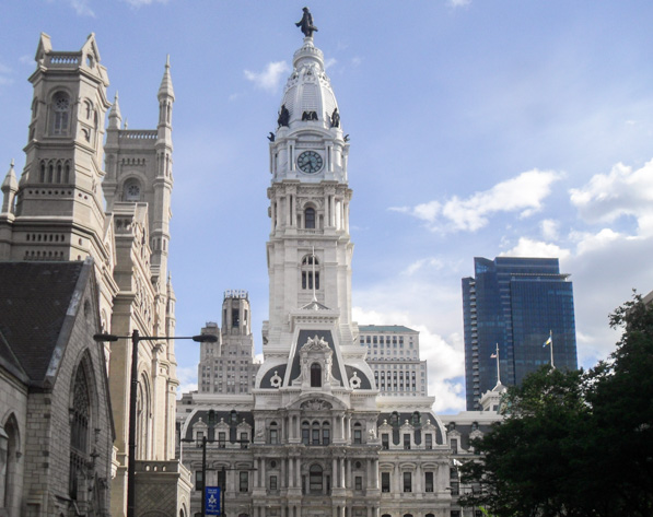 Philadelphia City Hall viewed from downtown streets beneath the statue of William Penn